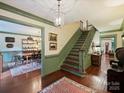 Grand foyer with hardwood floors, staircase, and views into the formal dining and living areas at 3040 Valencia Ter, Charlotte, NC 28211
