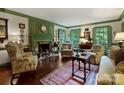 Inviting living room features a fireplace, wainscoting, and multiple seating arrangements at 3040 Valencia Ter, Charlotte, NC 28211