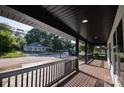 Spacious front porch with black railing offering neighborhood views at 307 N Catawba St, Lancaster, SC 29720