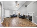 Well-lit living area showcasing vaulted ceilings, hardwood floors, a cozy fireplace, and comfortable seating at 311 Masters Dr, Rock Hill, SC 29732