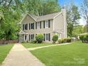 Charming two-story home with a well-manicured lawn, mature trees, and traditional siding at 3150 Driftwood Dr # B, Charlotte, NC 28205