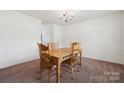 Inviting dining room with carpet, a wooden table with four chairs, and neutral walls at 3512 Gibbon Terrace Ct, Charlotte, NC 28269