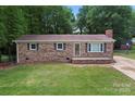 Inviting brick home with a well-kept lawn, classic shutters, and a welcoming front entrance at 393 Carson Dr, Gastonia, NC 28052