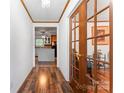 Inviting hallway with warm wood floors, decorative trim, and a view into the kitchen at 393 Carson Dr, Gastonia, NC 28052
