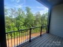 Private balcony featuring a scenic view of lush trees and verdant surroundings at 412 Nathaniel Way # Brx0052, Charlotte, NC 28213