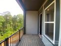 Inviting balcony offering a serene, tree-filled vista perfect for relaxing in a natural setting at 412 Nathaniel Way # Brx0052, Charlotte, NC 28213