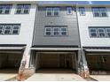Spacious two-car garage with gray siding in a modernly designed townhome complex at 412 Nathaniel Way # Brx0052, Charlotte, NC 28213