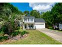 A well-maintained two-story home with a landscaped front yard, porch, and a two-car garage at 4332 Bathurst Dr, Charlotte, NC 28227