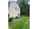 Expansive backyard featuring lush lawn and mature trees, creating a private outdoor space at 4905 Montibello Dr, Charlotte, NC 28226