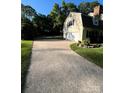 Long driveway leading to a two-car garage, offering ample parking and access to the home at 4905 Montibello Dr, Charlotte, NC 28226