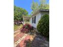 Well-maintained single-story home with brick trim, green shutters, and lush landscaping at 515 Willow St, Lincolnton, NC 28092