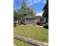 Inviting single-story home featuring a classic front porch, a well-maintained lawn, and colorful bushes at 515 Willow St, Lincolnton, NC 28092