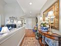 Inviting hallway featuring hardwood floors, neutral walls, and decorative accents at 5603 Ballinard Ln, Charlotte, NC 28277