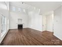 Spacious living room with soaring ceilings, fireplace, and hardwood floors is perfect for entertaining at 5745 Snapdragon Ln, Huntersville, NC 28078