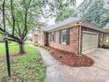 Lovely brick home with an attached garage and manicured landscaping at 6231 Kentwood Dr, Kannapolis, NC 28081