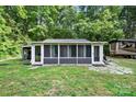 Relaxing sunroom with multiple screened windows and stone patio, ideal for enjoying the outdoors at 715 Potneck Rd, Salisbury, NC 28147