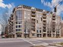 Modern multi-story condo building boasts brick facade, large windows, and balconies on a city street at 718 W Trade St # 704, Charlotte, NC 28202