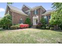 Brick home boasting an inviting entryway, neat landscaping, and classic architectural details for a timeless appeal at 7525 Blackgum Falls Ct, Huntersville, NC 28078