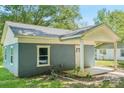 View of the front of the blue home, highlighting the window and covered porch at 814 Marve St, Gastonia, NC 28052
