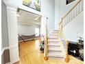Bright foyer with hardwood floors, coffered ceilings and staircase with wooden railings at 8218 Lynnewood Glen Dr, Charlotte, NC 28269
