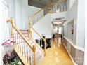 Bright foyer with wood floors, staircase, and decorative details leading into other areas of the house at 8218 Lynnewood Glen Dr, Charlotte, NC 28269