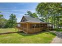 Beautiful log cabin with a wrap-around porch and scenic views of the lake at 993 Jackson Rd, Fort Lawn, SC 29714