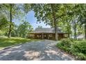 Inviting log cabin with a covered porch, set amongst mature trees at 993 Jackson Rd, Fort Lawn, SC 29714