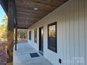 Inviting front porch featuring wood ceiling and supports, offering a cozy entryway at 107 Skyland Dr, Mount Gilead, NC 27306