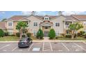Inviting exterior of a two-story condo building with well-maintained landscaping and ample parking at 11707 Ridgeway Park Dr, Charlotte, NC 28277
