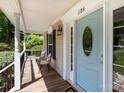 Inviting front porch with seating, stylish front door with oval window and transom at 1184 W Oak Dr, Rock Hill, SC 29732
