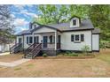 Attractive bungalow-style home with a covered front porch and tidy landscaping at 1208 Fordham Rd, Charlotte, NC 28208