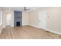 Open-concept living room showcasing new wood flooring, modern fireplace, and neutral paint at 1208 Fordham Rd, Charlotte, NC 28208