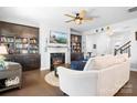 Cozy living room with a fireplace, built-in bookshelves, and comfortable seating at 13359 Caite Ridge Rd, Davidson, NC 28036