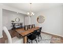 Dining room featuring a modern chandelier, decorative mirrors, and a wooden table with seating at 1359 Russell St, Rock Hill, SC 29730