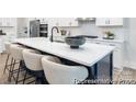 Close up on a modern kitchen island with a black base, white countertop, and seating for four at 1359 Russell St, Rock Hill, SC 29730
