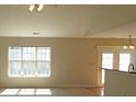 Open living area with plenty of natural light, featuring a kitchen bar and view of the backyard at 1367 Springview Ct, Rock Hill, SC 29732