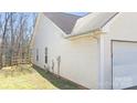 Side of the house showing cream-colored siding and a fenced in yard on a sunny day at 1367 Springview Ct, Rock Hill, SC 29732
