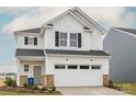 Charming two-story home featuring white siding, black shutters, and an attached two-car garage at 14015 Penbury Ln # 373, Charlotte, NC 28278