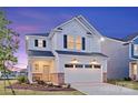 Charming two-story home featuring white siding, black shutters, and an attached two-car garage during twilight at 14015 Penbury Ln # 373, Charlotte, NC 28278