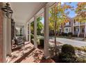Inviting covered porch features classic columns and a relaxing outdoor seating area at 155 Harper Lee St, Davidson, NC 28036