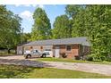 Detached multi-car garage with brick exterior and a white pickup truck parked outside at 1574 Jarrett Farm Rd, Newton, NC 28658