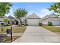 This home features a two-car garage and beautifully landscaped front yard at 16291 Raven Crest Dr, Indian Land, SC 29707