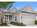 Close-up of the home's entrance, featuring a two-car garage and manicured landscaping at 16291 Raven Crest Dr, Indian Land, SC 29707