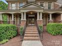 Inviting front entrance with brick steps, elegant columns, and a stylish double-door entry at 16319 Ashlyn Chase Ct, Charlotte, NC 28277