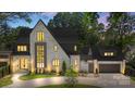Beautiful brick home exterior with elegant design, illuminated by soft outdoor lighting at 1719 Shoreham Dr, Charlotte, NC 28211