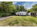 Wide view of home with mature trees and a well-maintained lawn showcasing its curb appeal at 1816 Anderson St, Charlotte, NC 28205