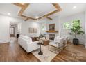 Bright living room with hardwood floors, fireplace, and stylish furniture under exposed beams at 1816 Parson St, Charlotte, NC 28205