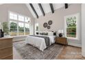 Comfortable primary bedroom with large windows, wood flooring, and decorative accents at 1816 Parson St, Charlotte, NC 28205
