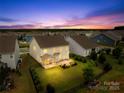 Aerial view of the backyard featuring a patio, screen porch, well manicured lawn, and privacy fence at 2007 Lydney Cir, Waxhaw, NC 28173
