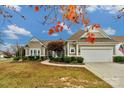 Charming single-Gathering home with manicured lawn, mature landscaping, and an attached two car garage at 2106 Yellowstone Dr, Fort Mill, SC 29707
